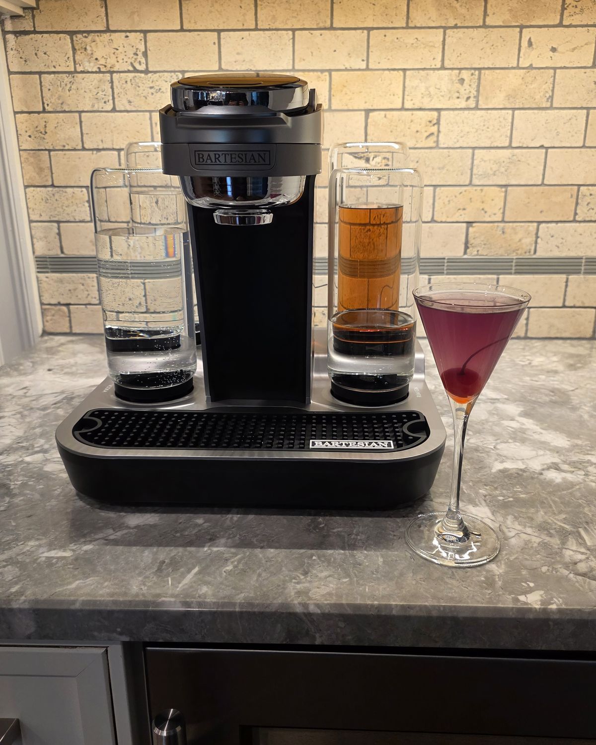 Bartesian Aviation pod cocktail in tall stemmed glass with maraschino cherry