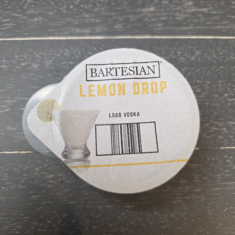 Top-down view of the Bartesian Lemon Drop capsule showing the label and Load Vodka instruction