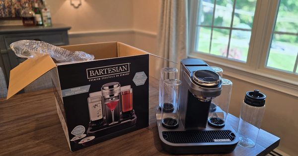 Bartesian Premier machine beside its retail box with glass spirit bottles
