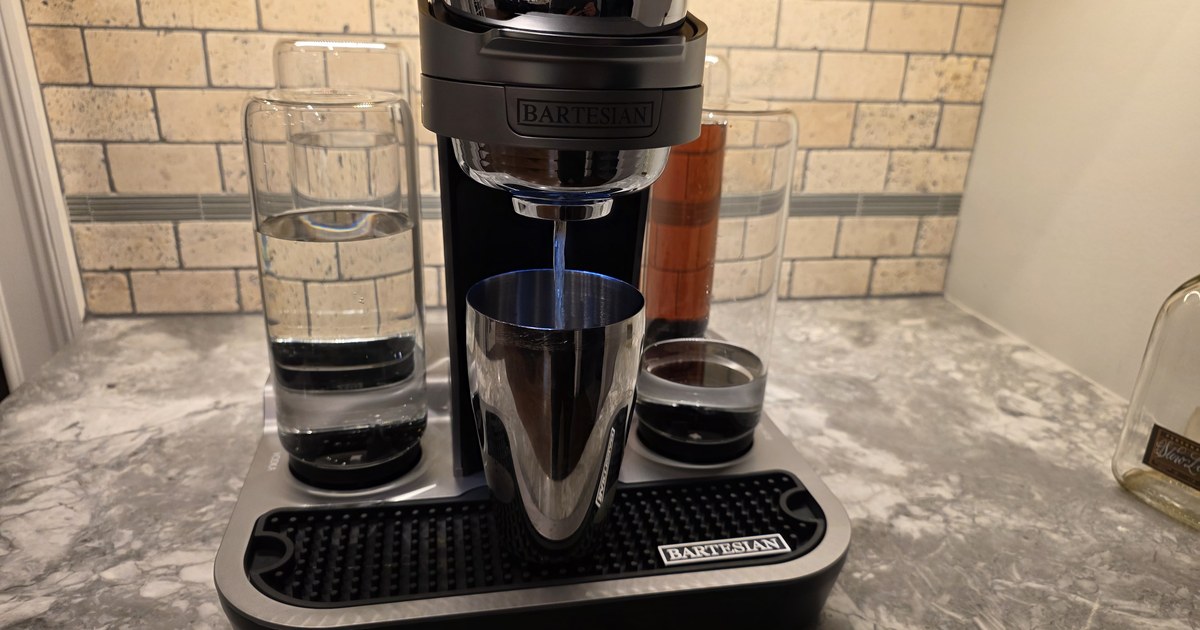 Bartesian Professional cocktail machine actively dispensing into a stainless steel cocktail shaker ..... blue LED illuminating the chrome, demonstrating the signature 'always shake' technique recommendation.