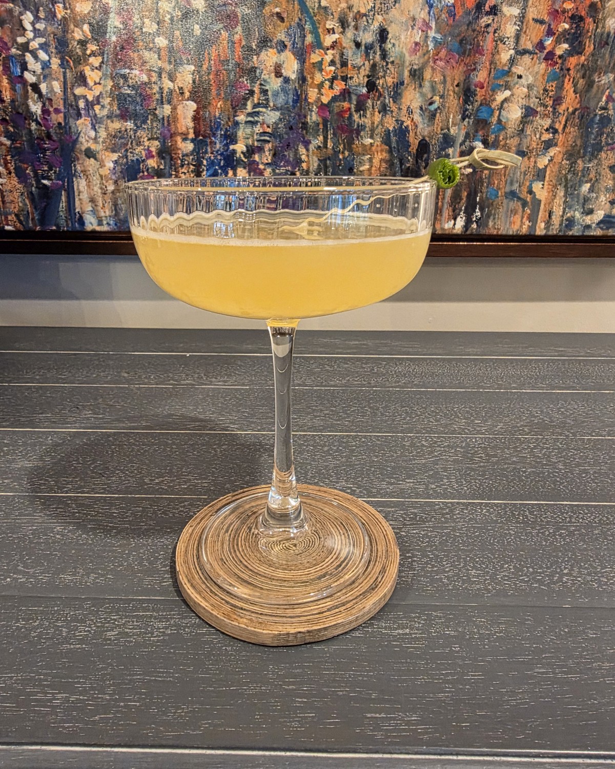 Bartesian Calamansi Daiquiri cocktail in a coupe glass with sunny yellow color and a lime garnish on the Bartesian machine
