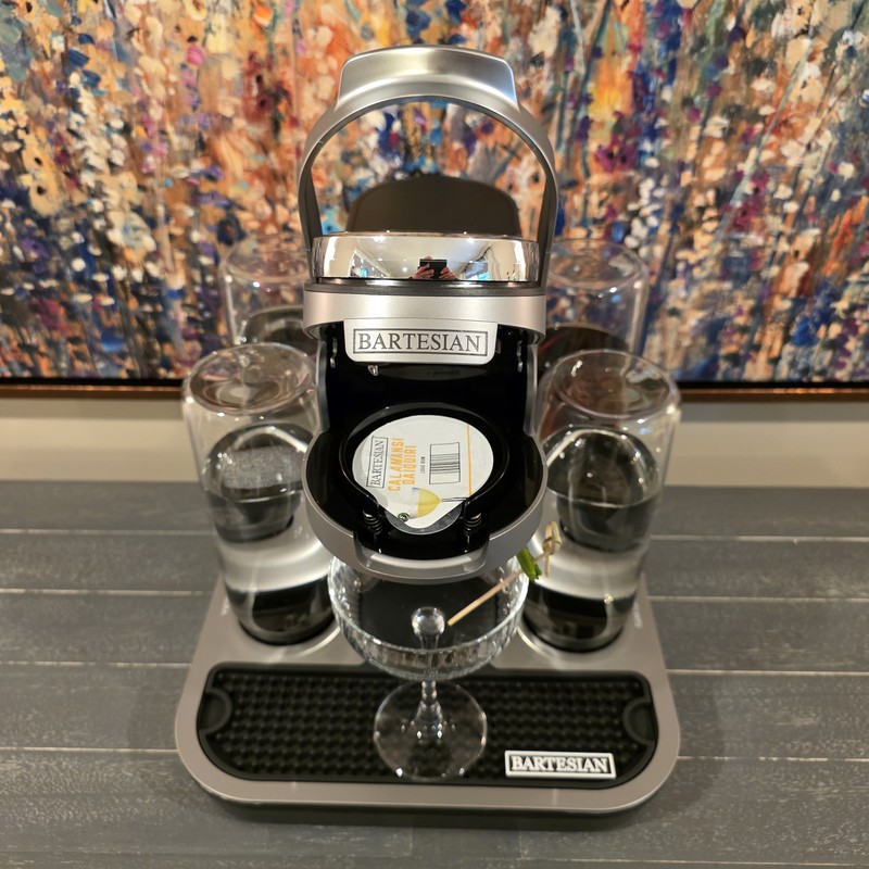 Bartesian Calamansi Daiquiri pod loaded in the Bartesian cocktail machine with coupe glass below ready to receive the pour