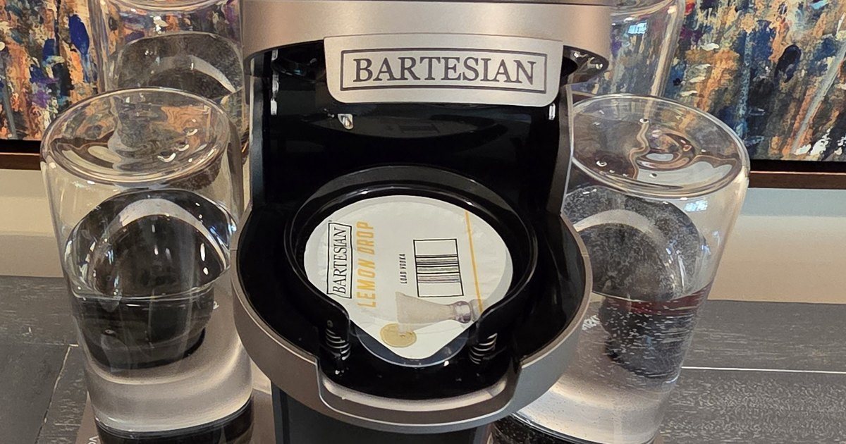 Bartesian cocktail machine with the lid open and a Lemon Drop pod seated in the chamber